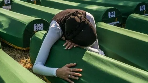 11 Jul 2012, Srebrenica, Bosnia and Herzegovina --- A Muslim woman grieves at the casket containing remains of a relative who lost his life at the hands of the Serbian Army in July, 1995. He joins 519 others now identified from mass graves and ready for burial after 13 years. --- Image by © David Bathgate/Corbis