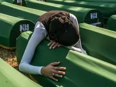 11 Jul 2012, Srebrenica, Bosnia and Herzegovina --- A Muslim woman grieves at the casket containing remains of a relative who lost his life at the hands of the Serbian Army in July, 1995. He joins 519 others now identified from mass graves and ready for burial after 13 years. --- Image by © David Bathgate/Corbis