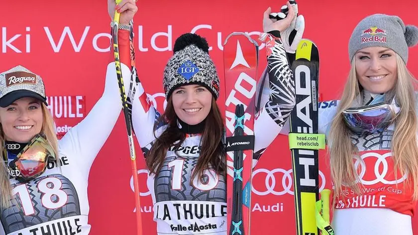 Liechtenstein's Tina Weirather, center, winner of an alpine ski women's World Cup super G race, celebrates on the podium with second-placed Switzerland's Lara Gut, left, and third-placed Lindsey Vonn, of the United States, in La Thuile, Italy, Sunday, Feb. 21, 2016. ANSA/ ANTONINO DI MARCO