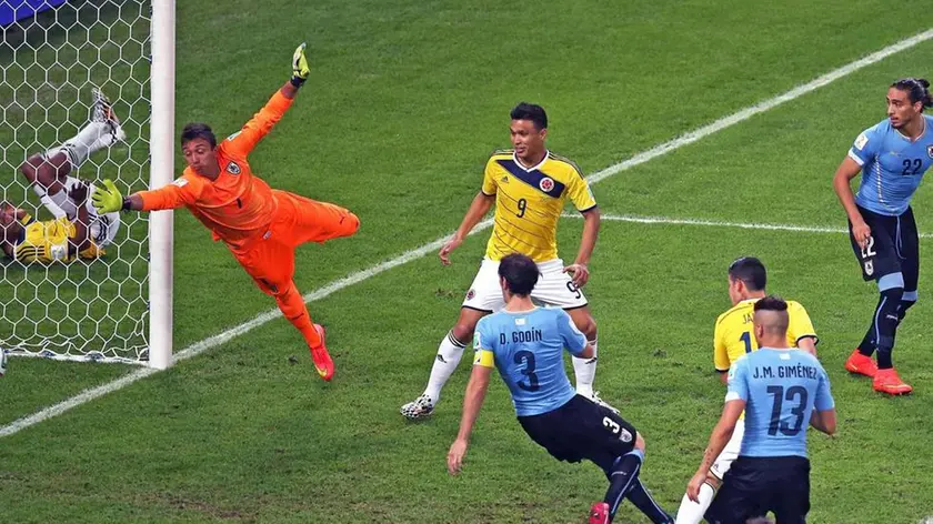 epa04288432 Uruguay's goalkeeper Fernando Muslera (L) receives the 2-0 goal from Colombia's James Rodriguez (2-R) during the FIFA World Cup 2014 round of 16 match between Colombia and Uruguay at the Estadio do Maracana in Rio de Janeiro, Brazil, 28 June 2014. (RESTRICTIONS APPLY: Editorial Use Only, not used in association with any commercial entity - Images must not be used in any form of alert service or push service of any kind including via mobile alert services, downloads to mobile devices or MMS messaging - Images must appear as still images and must not emulate match action video footage - No alteration is made to, and no text or image is superimposed over, any published image which: (a) intentionally obscures or removes a sponsor identification image; or (b) adds or overlays the commercial identification of any third party which is not officially associated with the FIFA World Cup) EPA/MARCELO SAYAO EDITORIAL USE ONLY