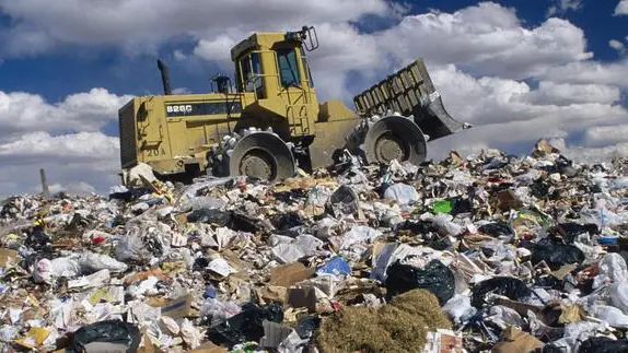 ca. 1991 --- Bulldozer on Trash Dump --- Image by © David Sailors/CORBIS