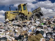 ca. 1991 --- Bulldozer on Trash Dump --- Image by © David Sailors/CORBIS