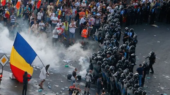 Protesters stand in front of police during a demonstration in Bucharest, Romania, August 10, 2018. Inquam Photos/Adriana Neagoe via REUTERS ATTENTION EDITORS - THIS IMAGE WAS PROVIDED BY A THIRD PARTY. ROMANIA OUT.