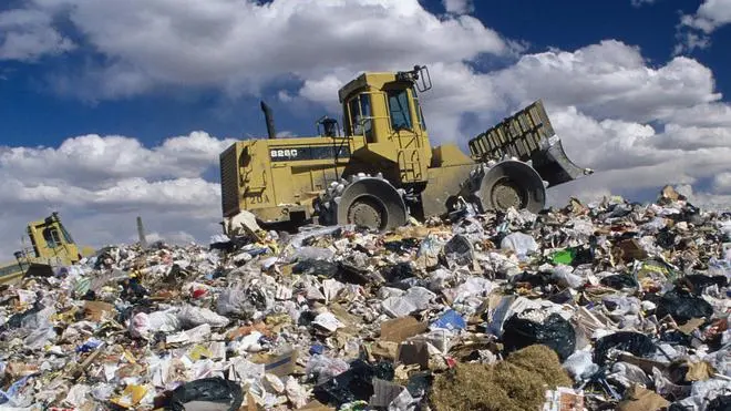 ca. 1991 --- Bulldozer on Trash Dump --- Image by © David Sailors/CORBIS