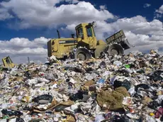 ca. 1991 --- Bulldozer on Trash Dump --- Image by © David Sailors/CORBIS