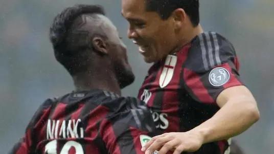Ac Milan forward Carlos Bacca (R) celebrates with his teammate M'baye Niang after scoring the lead of 1 to 0 during the Italian serie A soccer match between AC Milan and Genoa at Giuseppe Meazza stadium in Milan, 14 February 2016. ANSA / MATTEO BAZZI