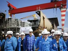 FILE - In this Wednesday, May 31, 2017 file photo, STX workers gather at the STX shipyard site in Saint-Nazaire, western France. The French and Italian governments are confident a deal will be announced Wednesday Sept.27 2017 allowing Italian shipbuilder Fincantieri to take control of a key French shipyard, ending a weeks-long disagreement between the countries. (Stephane Mahe/Pool Photo via AP, File)