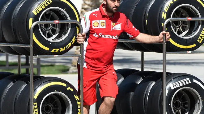 21 Feb 2014, Sakhir, Bahrain --- Ferrari mechanic with Pirelli tyres. Formula One Testing, Day Three, Bahrain International Circuit, Sakhir, Bahrain, Friday 21 February 2014. --- Image by © Sutton Images/Corbis