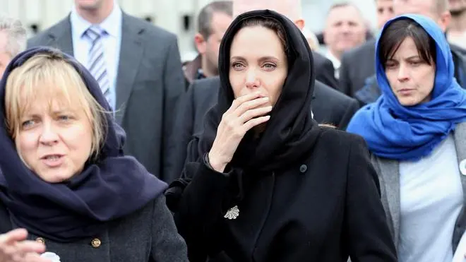 epa04144708 US actress Angelina Jolie (C) and British Foreign Secretary William Hague (not pictured) visit Potocari Memorial Center during her visit to the Memorial Center of Potocari, near Srebrenica, Bosnia and Hercegovina, 28 March 2014. Bosnian Serb troops killed up to 8,000 Bosnian Muslim men 19 years ago, after they captured the former eastern Bosnian Muslim enclave of Srebrenica, during the 1992-1995 war in Bosnia-Herzegovina. EPA/FEHIM DEMIR