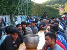 Immigrati in attesa del pasto alla parrocchia della Madonnina (foto Bumbaca)