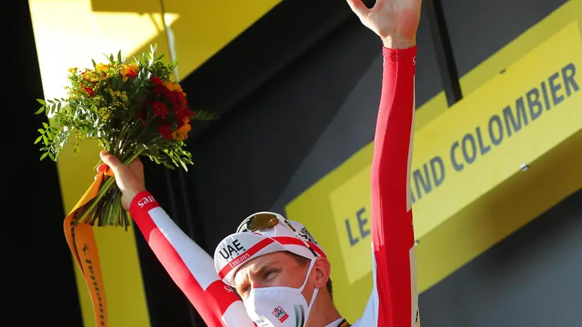 epa08666834 Slovenian rider Tadej Pogacar of the UAE-Team Emirates celebrates on the podium after winning the 15th stage of the Tour de France over 174.5km from Lyon to Grand Colombier, France, 13 September 2020. EPA/Thibault Camus / Pool