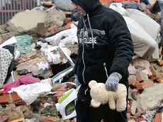 A man searches through the rubble of collapsed houses in Majska Poljana, Croatia, Wednesday, Dec. 30, 2020. A series of tremors have jolted central Croatia a day after a 6.3-magnitude earthquake killed at least seven people, injured dozens and left several towns and villages in ruins. (AP Photo)