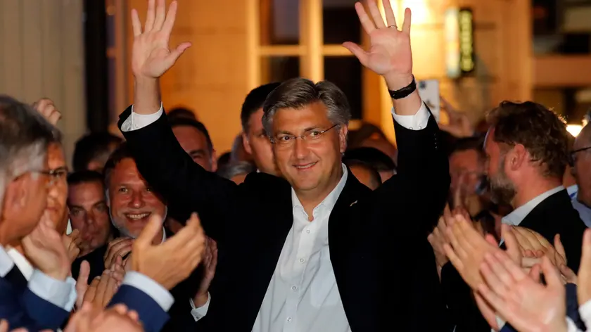 epa08529819 Croatian Prime Minister and leader of Croatian Democratic Union (HDZ) Andrej Plenkovic celebrates victory of the Parliamentary elections in downtown Zagreb, Croatia, 05 July 2020. Croatian people voted in Parliamentary elections to elect new authorities for next four years. EPA/ANTONIO BAT