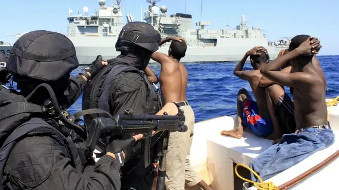 19 Nov 2009, Mogadishu, Somalia --- epa01938925 Portuguese marines team of the navy frigate NRP 'Alvares Cabral' secure crew members of a vessel during a boarding in the Golf of Aden, Somalia, 19 november 2009. The team intercepted and inspected the vessel and identified five suspect pirates, while gathering several operational information. EPA/CARLOS DIAS --- Image by © CARLOS DIAS/epa/Corbis