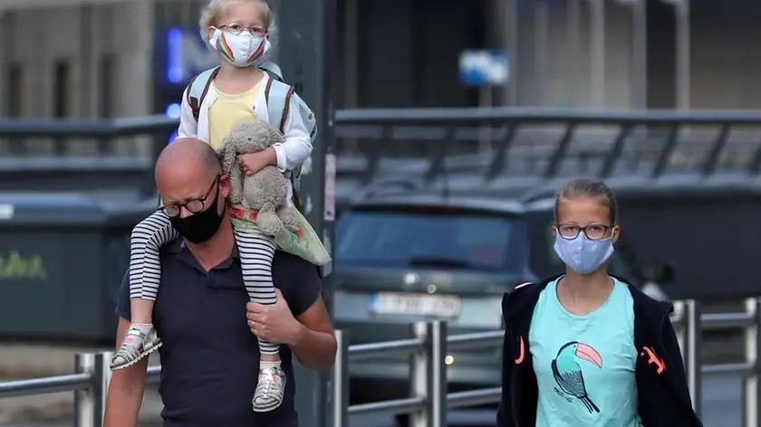 Family members wearing face masks walk the street near the European Union institutions buildings amid the coronavirus disease (COVID-19) outbreak, in Brussels, Belgium, September 11, 2020. REUTERS/Yves Herman