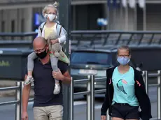 Family members wearing face masks walk the street near the European Union institutions buildings amid the coronavirus disease (COVID-19) outbreak, in Brussels, Belgium, September 11, 2020. REUTERS/Yves Herman