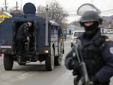 epa06630890 A member of Kosovo's police special unit stay guard near by the convoy carrying detained head of the Serbian governmentâs Office for Kosovo, Marko Djuric, in Mitrovica, Kosovo, 26 March 2018. Kosovo Police special unit detained head of the Serbian governmentâs Office for Kosovo, Marko Djuric, in northern city of Mitrovica for entering Kosovo despite a ban on his presence. EPA/VALDRIN XHEMAJ