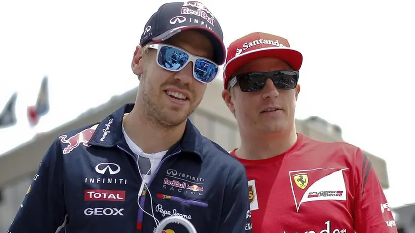 (FILES) A file picture dated 08 June 2014 of German Formula One driver Sebastian Vettel of Red Bull Racing (L) and Finnish Formula One driver Kimi Raikkonen of Scuderia Ferrari (R) during the drivers parade at the Gilles Villeneuve circuit in Montreal, Canada. ANSA/VALDRIN XHEMAJ