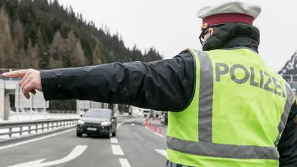 epa08283078 A police officer redirects a car for temperature check of the passenger at the Brenner border crossing between Austria and Italy at the Brenner pass, Austria, 10 March 2020. The Covid-19 coronavirus measures become effective at the border crossing points with Italy on 10 March morning. EPA/JAN HETFLEISCH