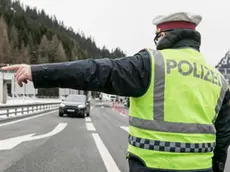 epa08283078 A police officer redirects a car for temperature check of the passenger at the Brenner border crossing between Austria and Italy at the Brenner pass, Austria, 10 March 2020. The Covid-19 coronavirus measures become effective at the border crossing points with Italy on 10 March morning. EPA/JAN HETFLEISCH