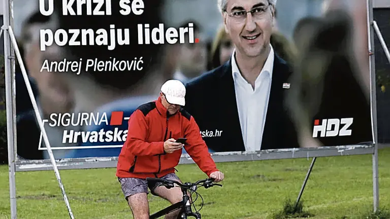 epa08513854 A man passes near by huge election posters with picture of Croatian Prime Minister Andrej Plenkovic of Croatian Democratic Union (HDZ) in downtown Zagreb, Croatia, 28 June 2020. Croatia will elect on 05 July new Parliament and Government. EPA/ANTONIO BAT