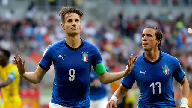 Italy's Andrea Pinamonti, center, celebrates after scoring his side's third goal from the penalty spot during the quarter final match between Italy and Mali at the U20 World Cup soccer in Tychy, Poland, Friday, June 7, 2019. (AP Photo/Sergei Grits)