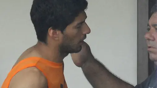 Uruguay striker Luis Suarez, center, talks with Uruguayan team members at the Serhs Hotel in Natal, Brazil, Thursday, June 26, 2014. FIFA banned Suarez from all football activities for four months on Thursday for biting an opponent at the World Cup, a punishment that rules him out of the rest of the tournament. (AP Photo/Vlademir Alexandre)