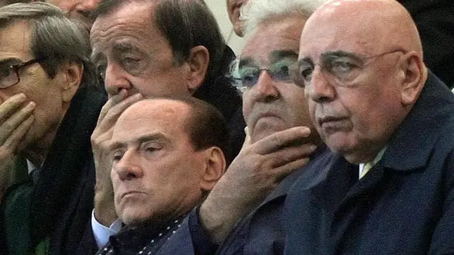 Former Italian Prime Minister Silvio Berlusconi (L) with Ceo of Ac Milan Adriano Galliani (R) and Flavio Briatore (C) during the UEFA Champions League Group B soccer match AC Milan vs Malaga CF at Giuseppe Meazza stadium in Milan, Italy, 06 November 2012. ANSA/MATTEO BAZZI