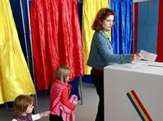 epa07077032 A woman is followed by her daughters while casting her ballot during the family re-definition referendum at a polling station in Bucharest, Romania, 07 October 2018. Romanians are going to polls on 06 and 07 October to vote on proposed constitutional changes, with Romania not currently recognizing same-sex couples. EPA/Bogdan Cristel