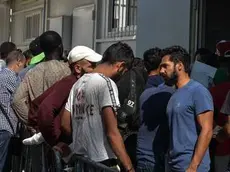 epa07042194 Refugees wait to be registered in the Asylum Service in the Identification Center of Moria, Lesvos island, Greece, 23 September 2018. Efforts to relieve overcrowding that have stretched facilities at the reception and identification centre to breaking point are now underway, with 400 scheduled to leave for the mainland on 24 September and another 1,080 within the week. The total number of migrants and refugees officially residing on Lesvos is currently 10,841 as of September 21, of which 8,706 live in Moria. The camp is divided into a bewildering puzzle of zones and sections, including a 'safe zone' where access is restricted to the unaccompanied underage girls that live there and staff that work there, as well as areas for new arrivals, a neighbouring olive grove managed by an NGO, all of which comprise the anarchic "town" that has grown around the Moria camp. EPA/PANAGIOTIS BALASKAS ATTENTION: This Image is part of a PHOTO SET