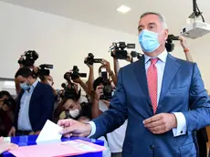 Montenegrin President Milo Djukanovic wearing a mask against the spread of the new coronavirus casts his ballot to vote in parliamentary elections at a polling station in Podgorica, Montenegro, Sunday, Aug. 30, 2020. Voters in Montenegro on Sunday cast ballots in a tense election that is pitting the long-ruling pro-Western party against the opposition seeking closer ties with Serbia and Russia. The parliamentary vote is marked by a dispute over a law on religious rights that is staunchly opposed by the influential Serbian Orthodox Church. (AP Photo/Risto Bozovic)