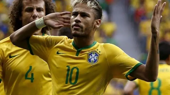epa04275936 Neymar of Brazil celebrates after scoring a goal during the FIFA World Cup 2014 group A preliminary round match between Cameroon and Brazil at the Estadio Nacional in Brasilia, Brazil, 23 June 2014. (RESTRICTIONS APPLY: Editorial Use Only, not used in association with any commercial entity - Images must not be used in any form of alert service or push service of any kind including via mobile alert services, downloads to mobile devices or MMS messaging - Images must appear as still images and must not emulate match action video footage - No alteration is made to, and no text or image is superimposed over, any published image which: (a) intentionally obscures or removes a sponsor identification image; or (b) adds or overlays the commercial identification of any third party which is not officially associated with the FIFA World Cup) EPA/MARCELO SAYAO EDITORIAL USE ONLY