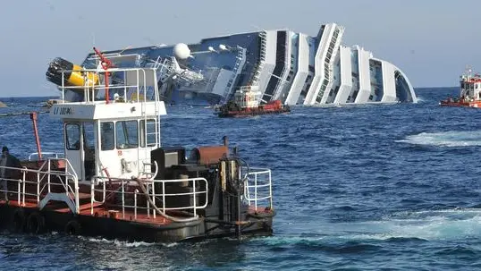 Technicians and firemen work at the cruise liner Costa Concordia liying aground in front of the Isola del Giglio (Giglio island) on January 30, 2012 after hitting underwater rocks on January 13..ANSA/LUCA ZENNARO
