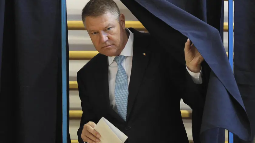 epa07985295 Romanian President Klaus Iohannis holds his ballot as he exits the voting booth at the Jean Monet polling station during the first round of presidential elections in Bucharest, Romania, 10 November 2019. Iohannis is running for a second mandate on behalf of the National Liberal Party (PNL). Romanians are voting in the first round of the presidential elections, and if none of the candidates will win more than 50 percent from the total number of cast votes, there will be a second round held on 24 November. EPA/ROBERT GHEMENT