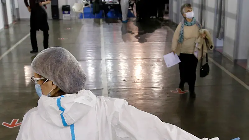 People arrive to receive a dose of Sinopharm COVID-19 vaccine at Belgrade Fair makeshift vaccination center in Belgrade, Serbia, Wednesday, Feb. 17, 2021. Serbia, a country of 7 million, has so far vaccinated some 1 million people, mainly with the Chinese Sinopharm vaccine and Russian Sputnik V, and to a lesser extent with the Pfizer jab. (AP Photo/Darko Vojinovic)