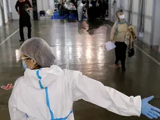 People arrive to receive a dose of Sinopharm COVID-19 vaccine at Belgrade Fair makeshift vaccination center in Belgrade, Serbia, Wednesday, Feb. 17, 2021. Serbia, a country of 7 million, has so far vaccinated some 1 million people, mainly with the Chinese Sinopharm vaccine and Russian Sputnik V, and to a lesser extent with the Pfizer jab. (AP Photo/Darko Vojinovic)