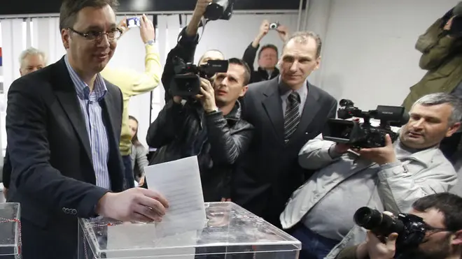 Serbian Progressive Party leader Aleksandar Vucic casts his ballot at a polling station in Belgrade, Serbia, Sunday, March 16, 2014. Serbs are voting in an early parliamentary election that is expected to tighten the grip on power of the ruling populists, who have become popular by promising to fight crime and corruption in the troubled Balkan nation seeking EU entry. (AP Photo/Darko Vojinovic)