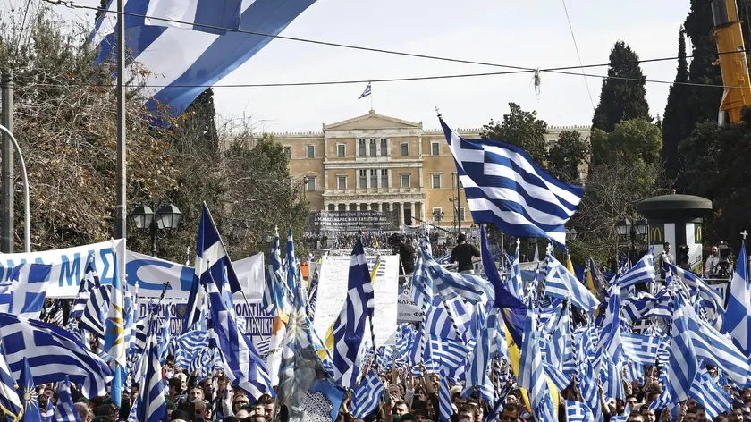 epa06496070 Protesters hold Greek flags and shout slogans during a massive rally over the name of the Former Yugoslav Republic of Macedonia (FYROM) against to its use of the name 'Macedonia' amid a revival of efforts to find a solution between the two countries, in Athens, Greece, 04 February 2018. EPA/ALEXANDROS VLACHOS