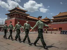 epa08428938 Chinese People's Liberation Army (PLA) soldiers wearing protective face masks march past the entrance to the Forbidden City, in Beijing, China, 18 May 2020. China will hold the Chinese People's Political Consultative Conference (CPPCC) on 21 May and the National People's Congress (NPC) on 22 May after the two major political meetings initially planned to be held in March 2020 were postponed amid the coronavirus outbreak. EPA/ROMAN PILIPEY