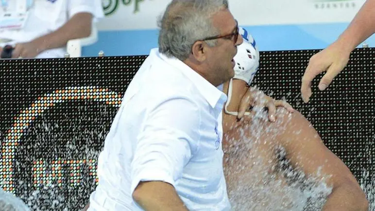 epa04333109 Head coach Alessandro Campagna and player Fabio Baraldi (L-R) of Italy celebrate after Italy defeated Montenegro in their match for the mens bronze medal of European Water Polo Championships in Hajos Alfred Swimming Pool in Budapest, Hungary, 27 July 2014. EPA/Tamas Kovacs