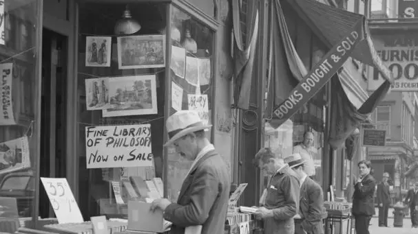 ca. 1938 --- Men Browsing Outside Bookstore --- Image by © Photo Collection Alexander Alland, Sr./CORBIS