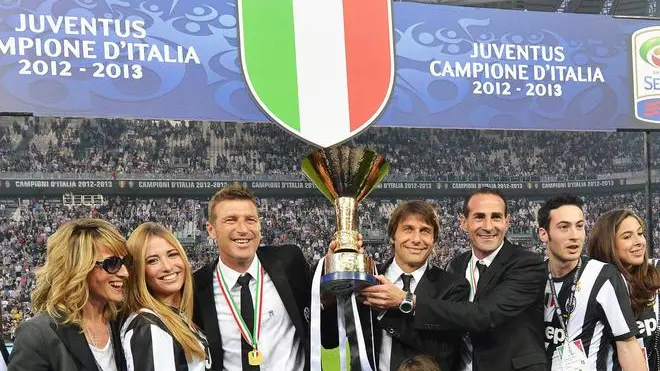 Italian coach of Juventus, Antonio Conte, with Angelo Alessio and Massimo Carrera celebrate the Scudetto, the Italian Serie A trophy, during the ceremony at the end of the Italian Serie A soccer match Juventus FC vs Cagliari Calcio at Juventus Stadium in Turin, Italy, 11 May 2013. ANSA/DI MARCO
