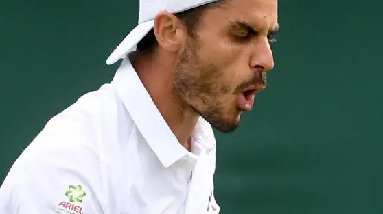 epa07687545 Thomas Fabbiano of Italy in action against Stefanos Tsitsipas of Greece during their first round match at the Wimbledon Championships at the All England Lawn Tennis Club, in London, Britain, 01 July 2019. EPA/FACUNDO ARRIZABALAGA EDITORIAL USE ONLY/NO COMMERCIAL SALES