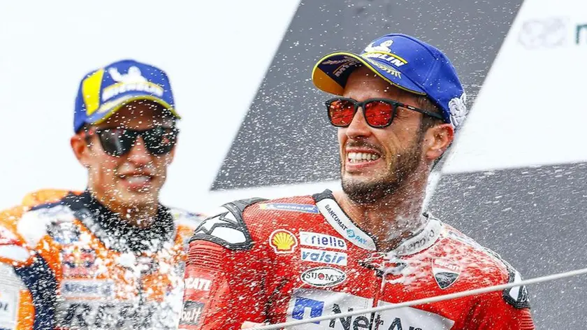 epa07768282 f.l. second placed Spanish MotoGP rider Marc Marquez of Repsol Honda Team race winner Italian MotoGP rider Andrea Dovizioso of Ducati Team during th winner ceremony for the MotoGP of Austria at the Red Bull Ring in Spielberg, Austria, on August 11, 2019. EPA/Gerhard Schiel