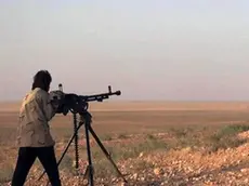 In this picture released on Wednesday, May 20, 2015 by the website of Islamic State militants, an Islamic State fighter aims his weapon during a battle against the Syrian government forces on a road between Homs and Palmyra, Syria. Islamic State militants overran the famed archaeological site at Palmyra early on Thursday, just hours after seizing the central Syrian town, activists and officials said, raising concerns the extremists might destroy some of the priceless ruins as they have done in neighboring Iraq. (The website of Islamic State militants via AP)