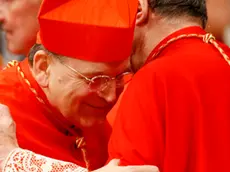 Newly-appointed US Cardinal Raymond Leo Burke, left, hugs Cardinal Giovanni Lajolo during a consistory inside St. Peter's Basilica, at the Vatican, Saturday, Nov. 20, 2010. Pope Benedict XVI formally created 24 new cardinals on Saturday amid cheers in St. Peter's Basilica, bringing a mostly Italian group into the elite club that will eventually elect his successor. (AP Photo/Pier Paolo Cito)