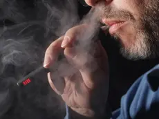 BERLIN, GERMANY - MARCH 01: In this photo illustration the owner of a shop that sells electronic cigarettes demonstrates how to use one on March 1, 2012 in Berlin, Germany. The German government has announced that it classifies the liquids used in electronic cigarettes as pharmaceuticals because the liquids contain nicotine, and that sale of the liquids requires certification. An estimated 1.2 to 2 million people in Germany use electronic cigarettes, and the retailers that sell the liquids now face the problem that they are breaking the law. Electronic cigarettes have thus far been in a legal grey area with some lawmakers pushing for conclusive studies to determine their potential health effects. (Photo Illustration by Sean Gallup/Getty Images)