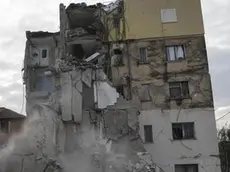 In this Wednesday, Nov. 27, 2019 photo, dust rises from the falling parts of a destroyed building during an aftershock in Thumane, western Albania. The 6.4-magnitude quake that hit Albania's Adriatic coast before dawn on Tuesday has left at least 51 people dead, around 2,000 others injured and about 4,000 people homeless. (ANSA/AP Photo/Petros Giannakouris) [CopyrightNotice: Copyright 2019 The Associated Press. All rights reserved]