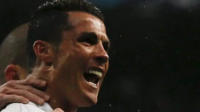 epaselect epa05256035 Real Madrid's Portuguese striker Cristiano Ronaldo jubilates his second goal against Wolfsburg during the UEFA Champions League quarter final second leg match played at Santiago Bernabeu stadium in Madrid, Spain on 12 April 2016. EPA/JUANJO MARTIN