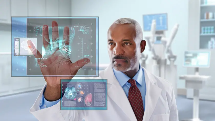 Black doctor looking at digital display in doctor's office